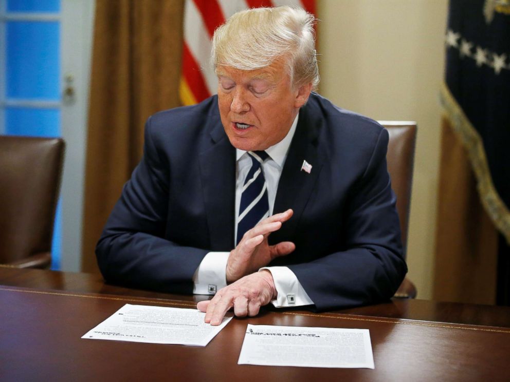 PHOTO: President Donald Trump reads from prepared remarks as he speaks about his summit meeting in Finland with Russian President Vladimir Putin at the start of a meeting with members of Congress at the White House in Washington, July 17, 2018.