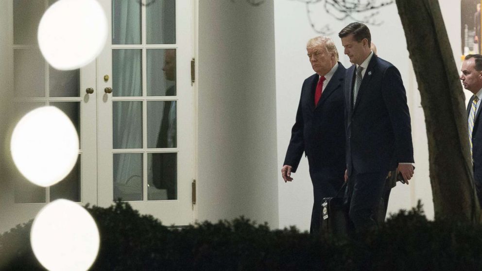 President Donald J. Trump speaks with White House Secretary Rob Porter as they return to the White House in Washington, Dec. 4, 2017.