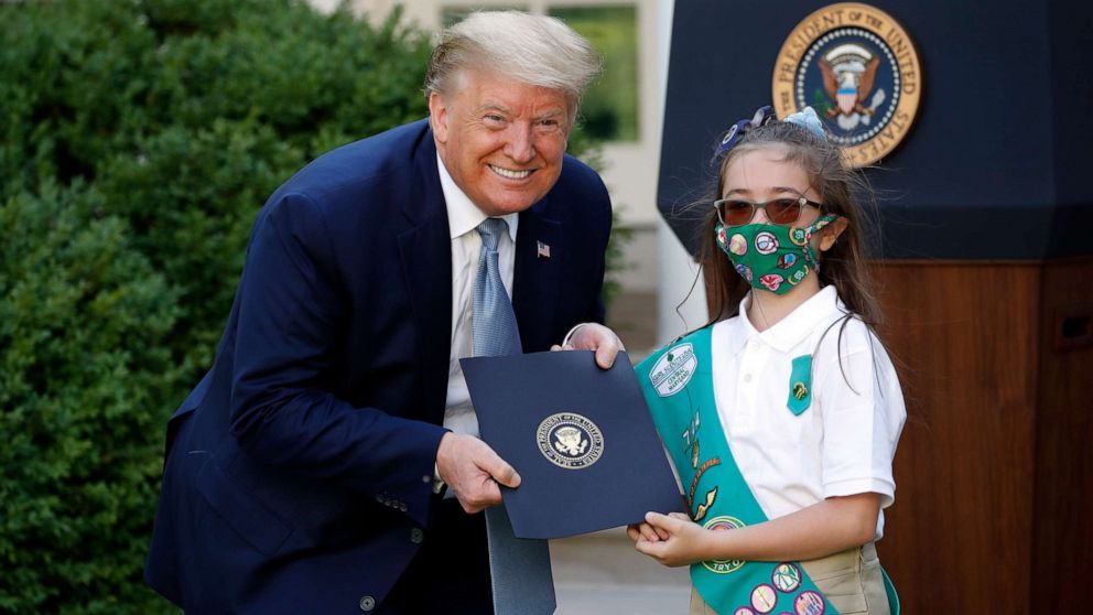 PHOTO: President Donald Trump poses for a photo with Girl Scout Troop 744 member Lauren Matney during a presidential recognition ceremony in the Rose Garden of the White House, May 15, 2020, in Washington.