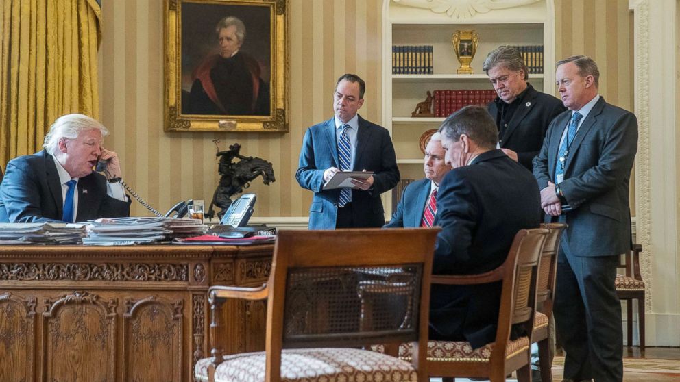PHOTO: President Donald Trump, accompanied by Reince Priebus, Vice President Mike Pence, Michael Flynn, Steve Bannon, and Sean Spicer, speaks on the phone with Russian President Vladimir Putin at the White House, Jan. 28, 2017.