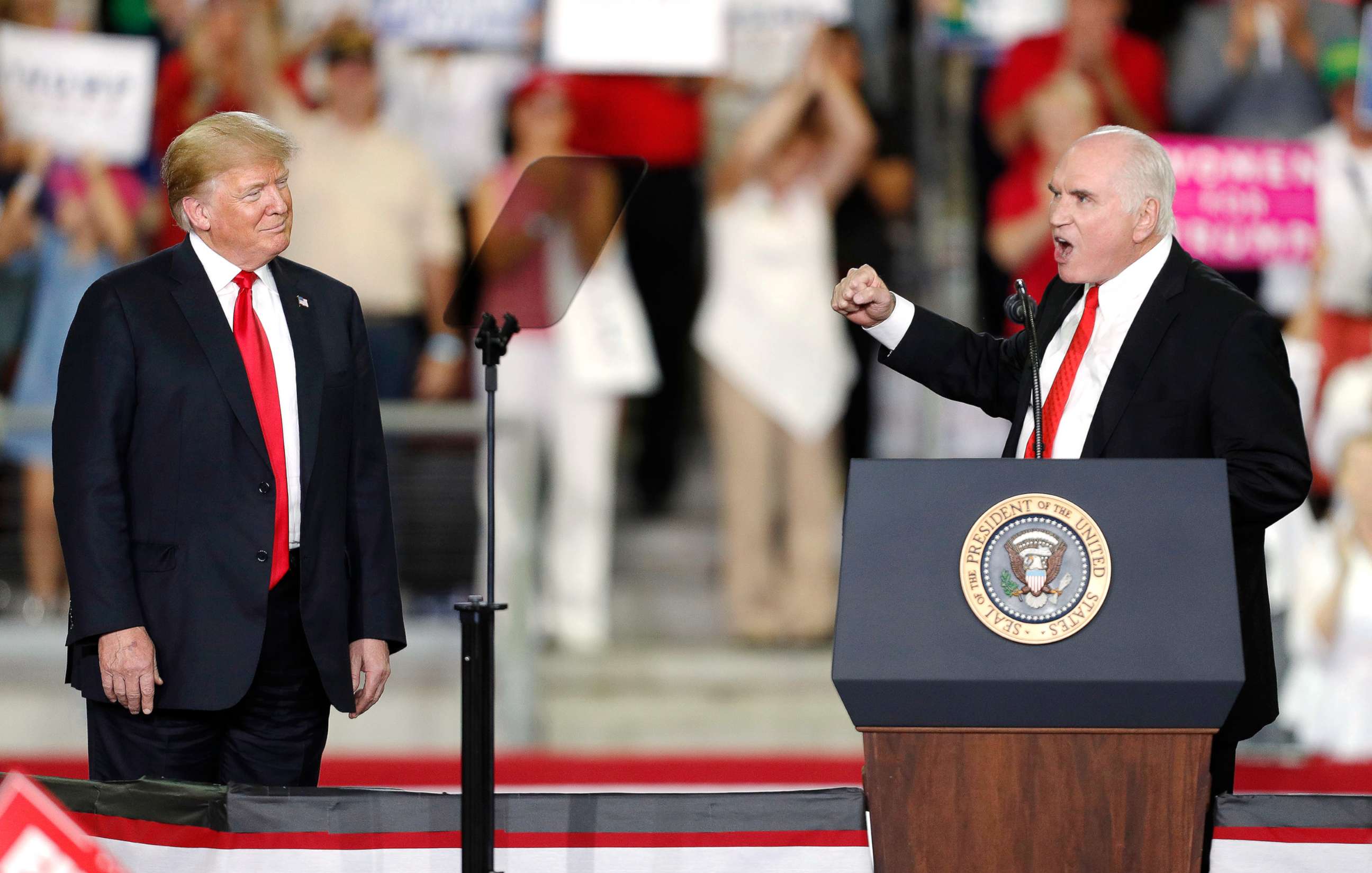 PHOTO: President Donald Trump listens to Pennsylvania Republican Congressman Mike Kelly speak to supporters during a rally in Erie, Pa., Oct. 10, 2018.
