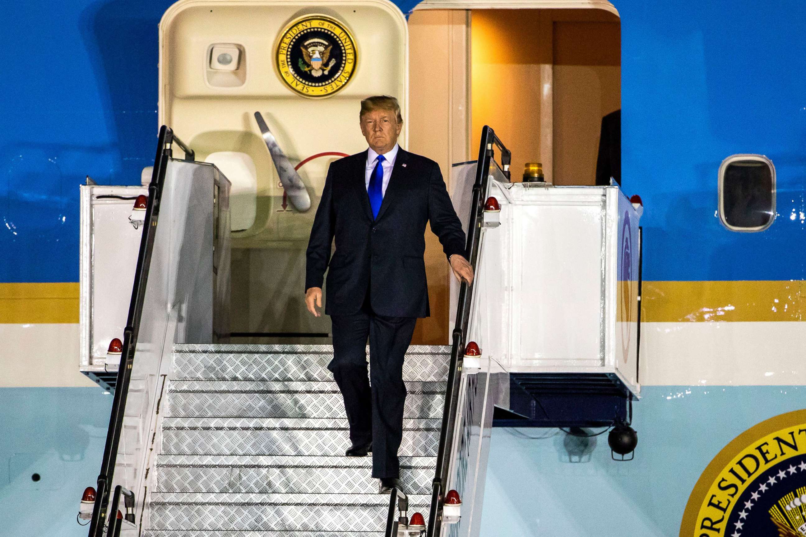 PHOTO: President Donald Trump walks off Air Force One as he arrives at the Paya Lebar Air Base in Singapore, June 10, 2018.