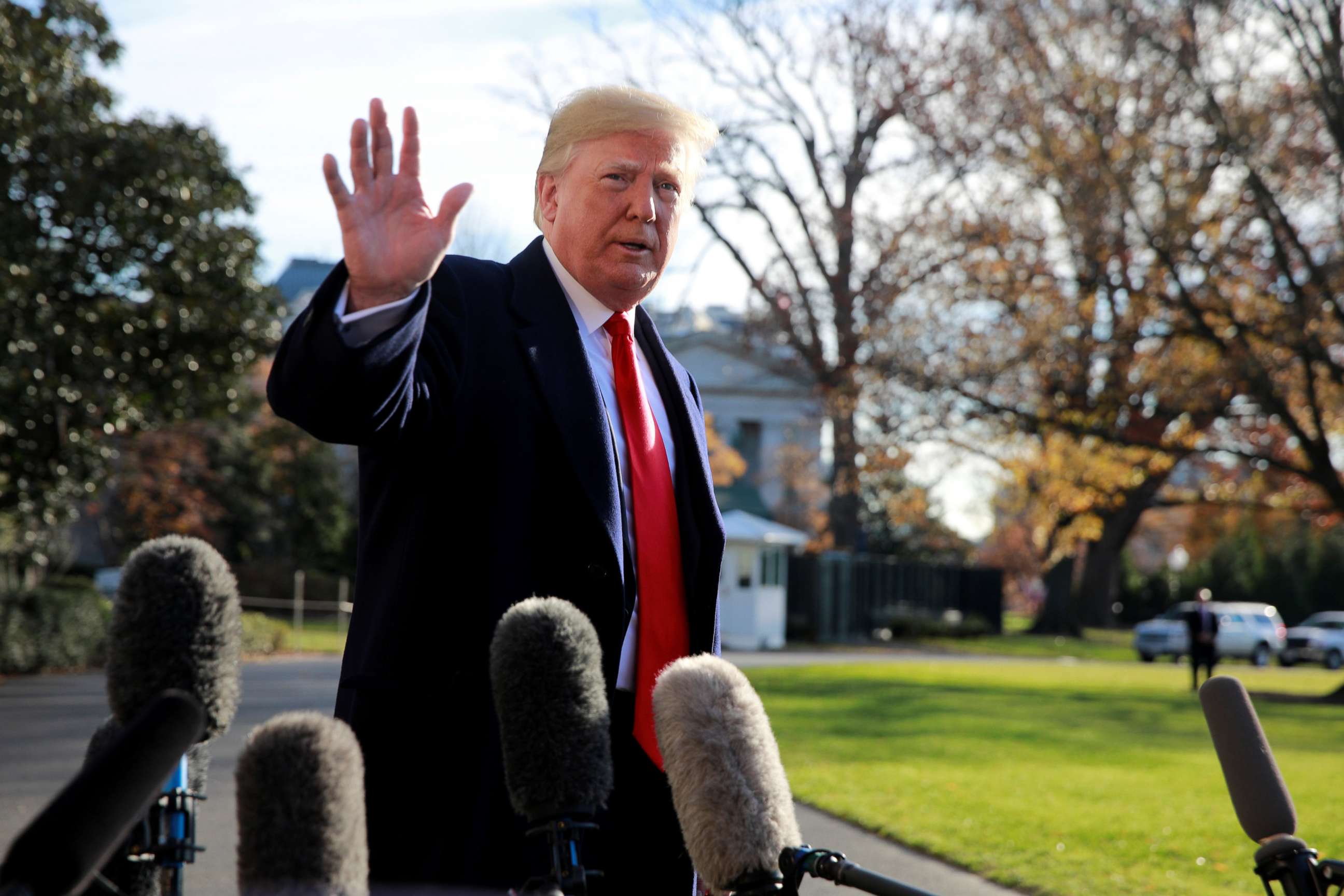PHOTO: President Donald Trump waves to the press as he prepares to depart the South Lawn at the White House in Washington, Dec. 7, 2018.