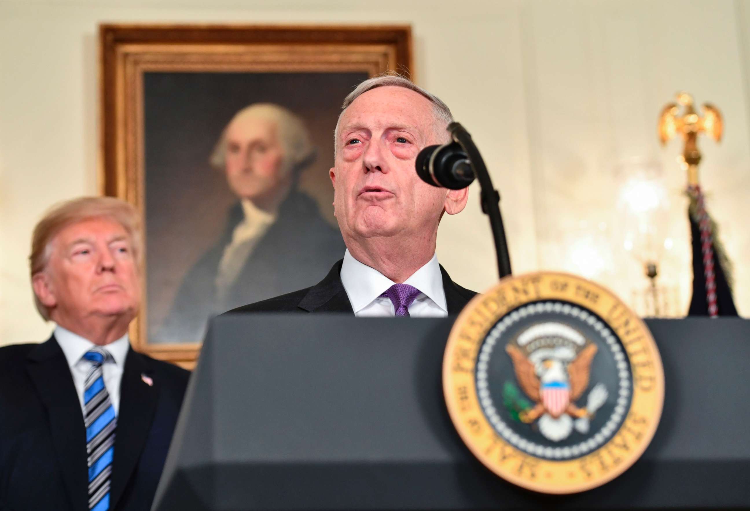 PHOTO: President Donald Trump looks on as Secretary of Defense James Mattis speaks about the spending bill during a press conference in the Diplomatic Reception Room at the White House on March 23, 2018.