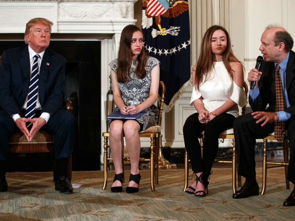 PHOTO: From left, President Donald Trump, Marjory Stoneman Douglas High School students Carson Abt and Ariana Klein, listen as Carsons father Frederick Abt, speaks in the State Dining Room of the White House in Washington, D.C., Feb. 21, 2018.