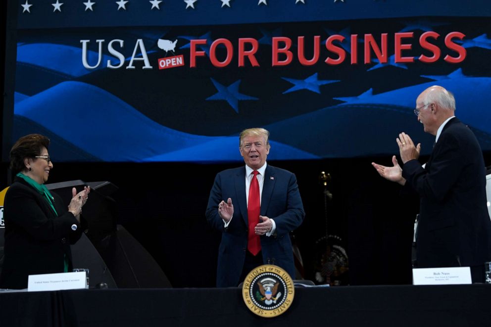 PHOTO: President Donald Trump, center, arrives to speak during a roundtable discussion at Nuss Truck and Equipment in Burnsville, Minn., Monday, April 15, 2019, during an event to tout the 2017 tax law.