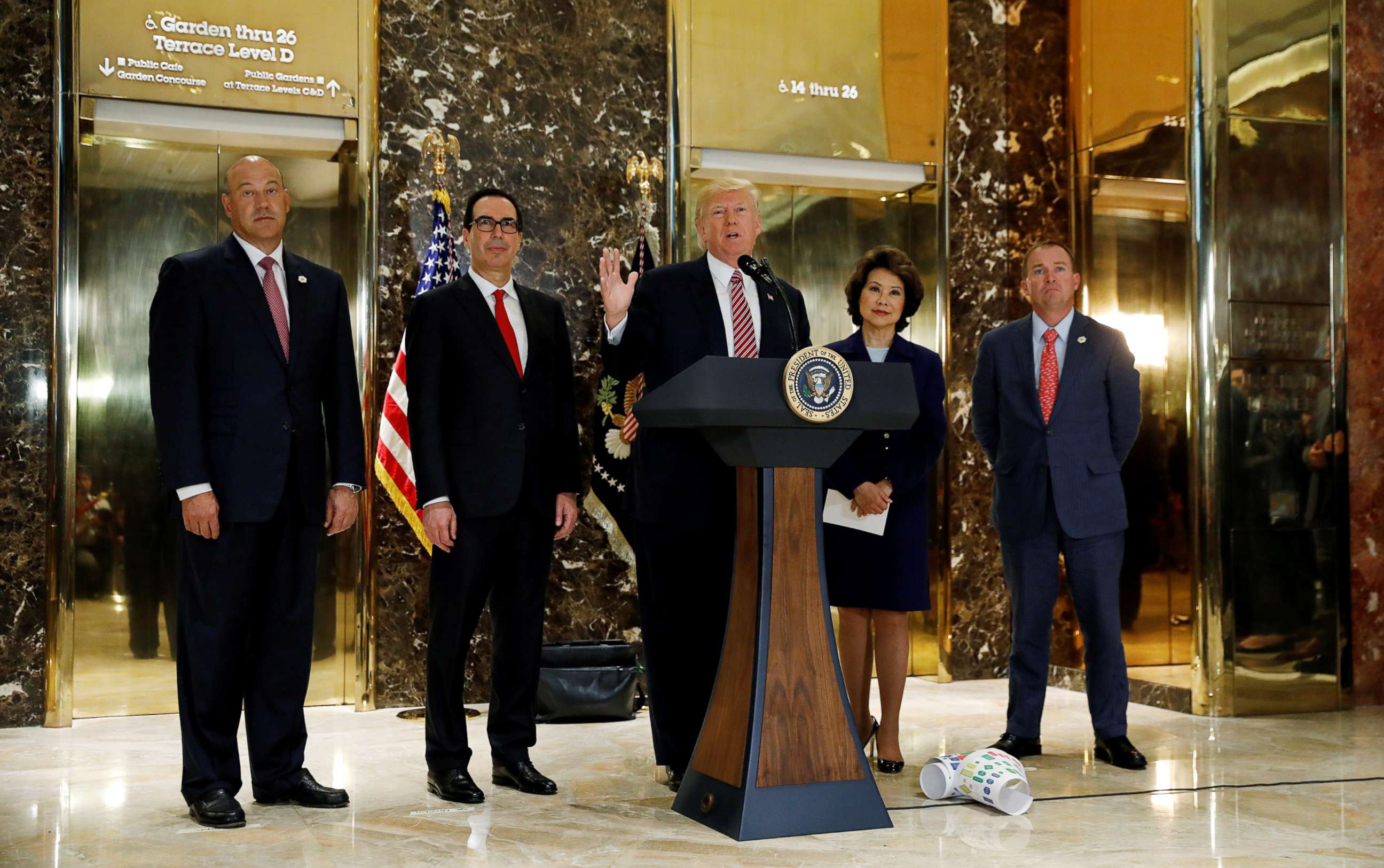 PHOTO: President Donald Trump is flanked by officials as he speaks about the violence in Charlottesville while talking to the media in the lobby of Trump Tower in New York, Aug. 15, 2017.