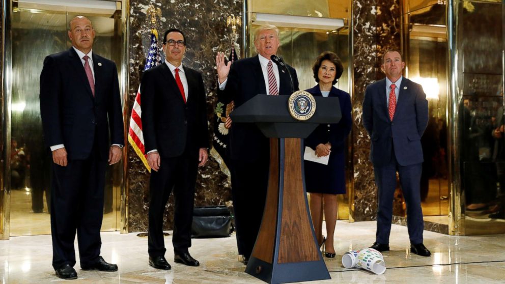 PHOTO: President Donald Trump is flanked by officials as he speaks about the violence in Charlottesville while talking to the media in the lobby of Trump Tower in New York, Aug. 15, 2017.