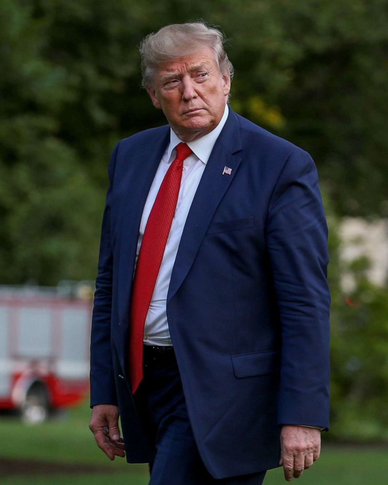 PHOTO: President Donald Trump walks on the South Lawn of the White House after returning from a trip to Kentucky, in Washington, Aug. 21, 2019.