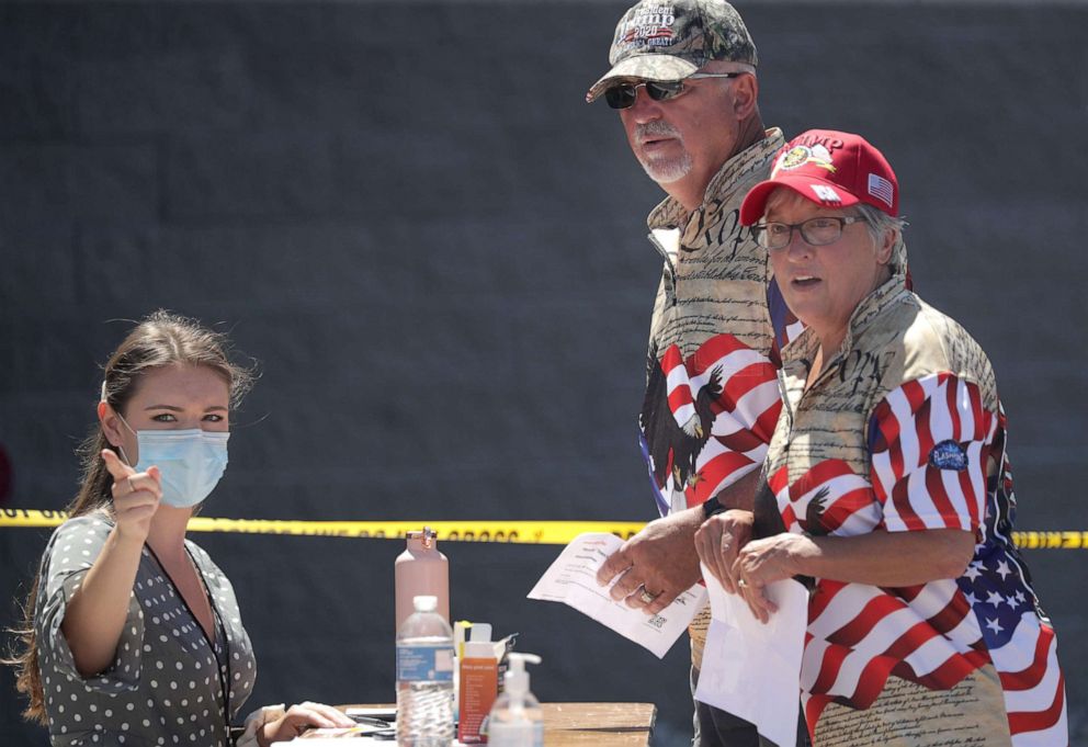 PHOTO: Supporters check in at a registration station while attending President Donald Trump's town hall meeting with Fox News Channel host Sean Hannity at Green Bay Austin Straubel International Airport, June 25, 2020, in Ashwaubenon, Wisc.