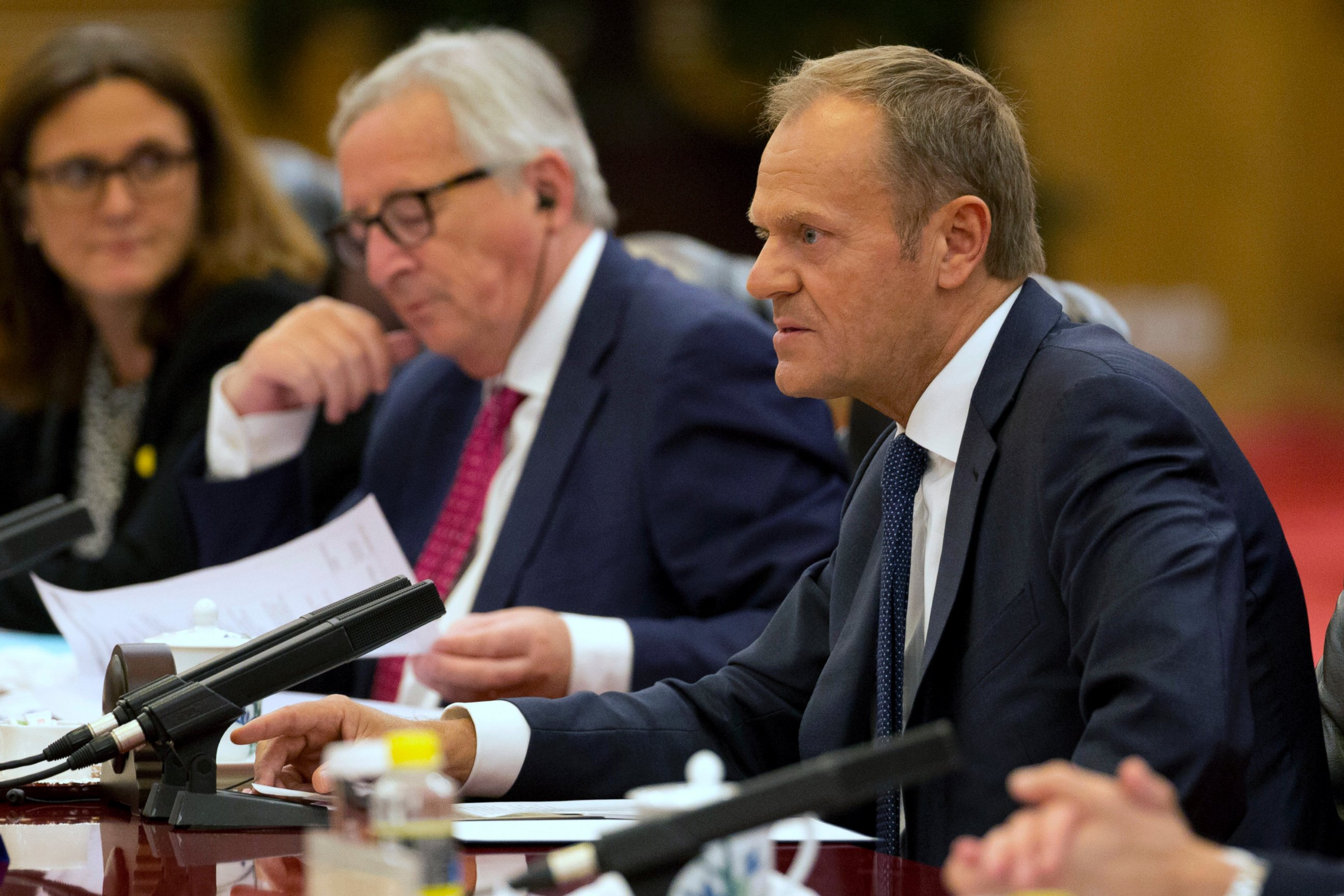 European Council President Donald Tusk, right speaks near European Commission President Jean-Claude Juncker during a meeting with Chinese Premier Li Keqiang, unseen at the Great Hall of the People in Beijing, China, Monday, July 16, 2018.