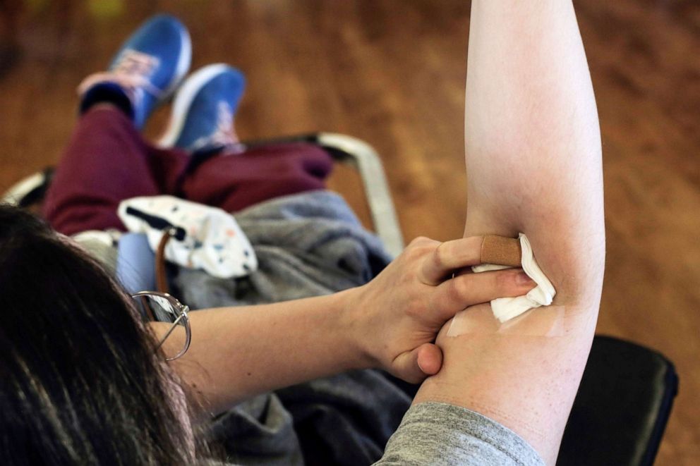 PHOTO: A donor holds her arm after giving blood at the Shoreline Masonic Lodge in Shoreline, Wash., March 15, 2020.