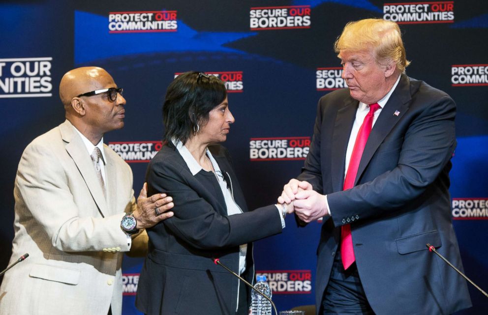 PHOTO: President Donald Trump embraces Evelyn Rodriguez whose daughter was killed by MS-13 gang members, alongside her husband Freddy Cuevas, during a roundtable discussion on immigration in Bethpage, New York, May 23, 2018.