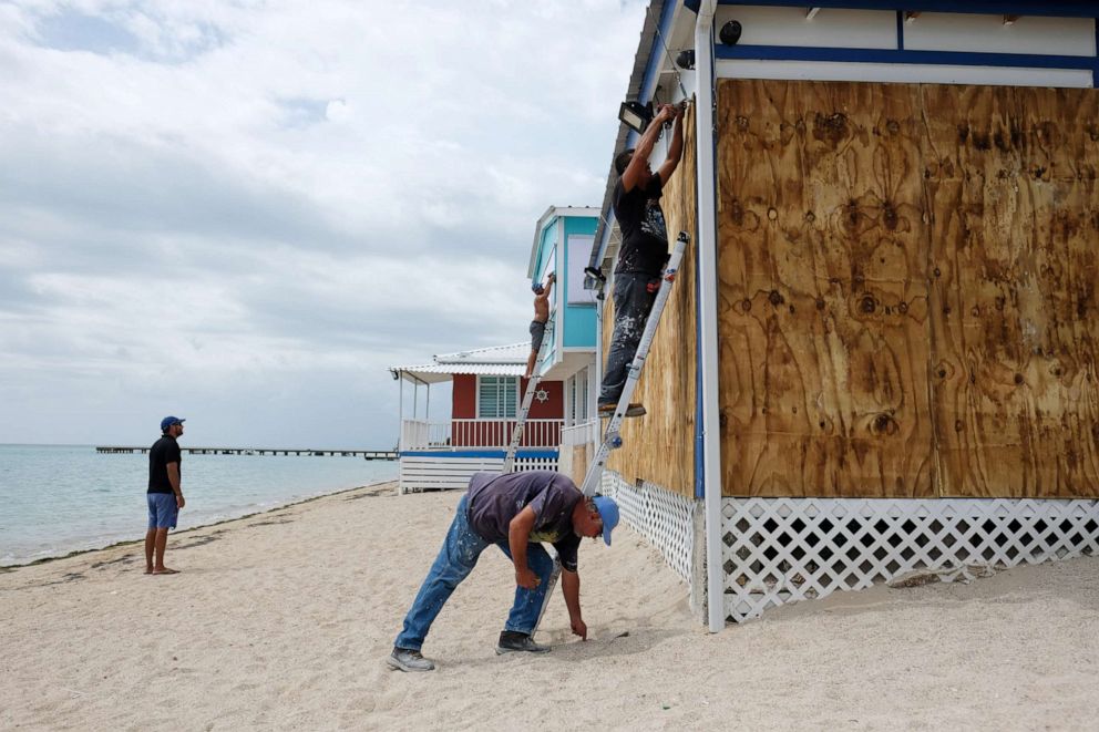 PHOTO: A man boards up the windows of a beach restaurant in the tourist zone of El Combate as Tropical Storm Dorian approaches in Cabo Rojo, Puerto Rico, Aug. 27, 2019.