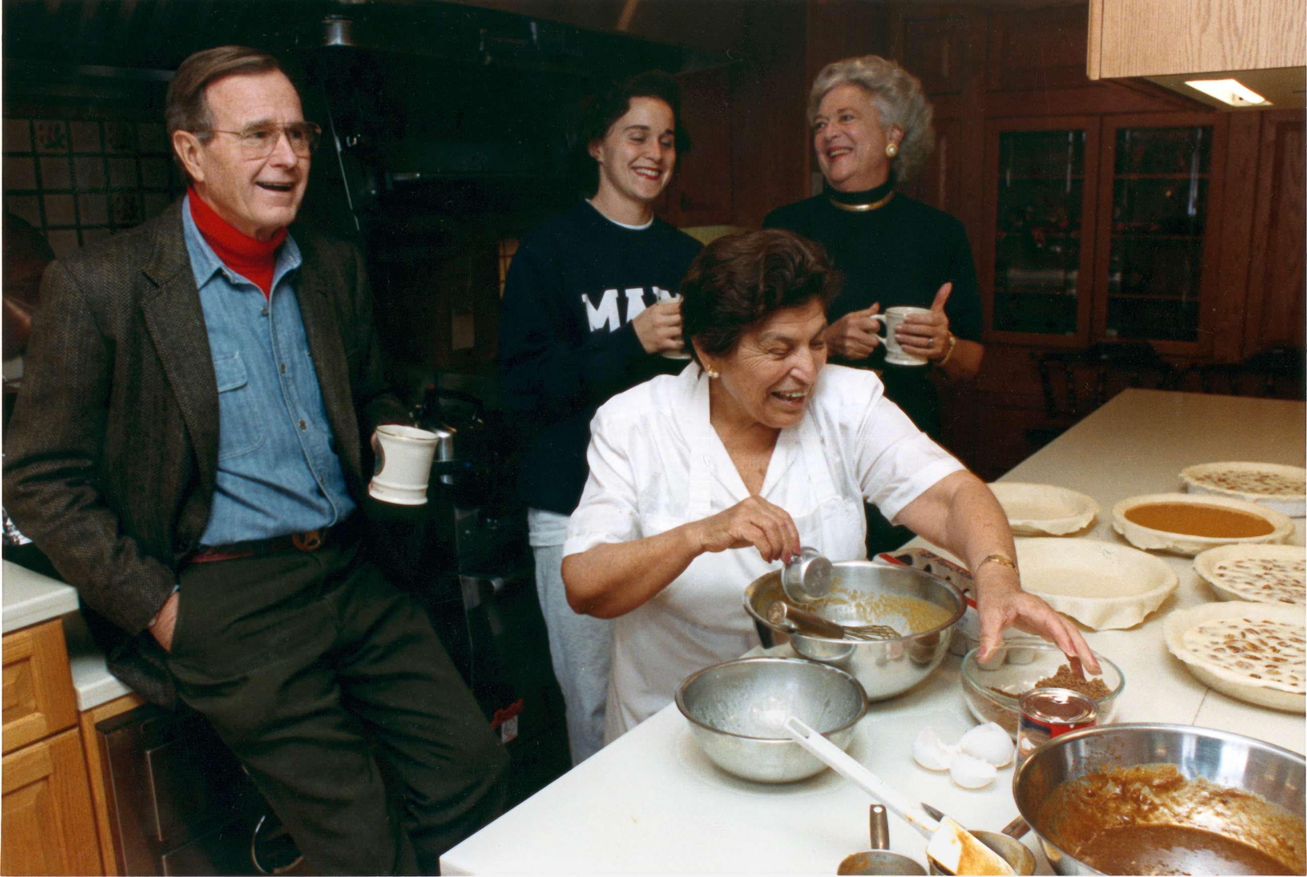 PHOTO: President George H.W. Bush shares drink with his daughter, Dorothy, and first lady Barbara Bush in the kitchen at Camp David, Maryland on Nov. 23, 1989 as Thanksgiving Dinner is being prepared.