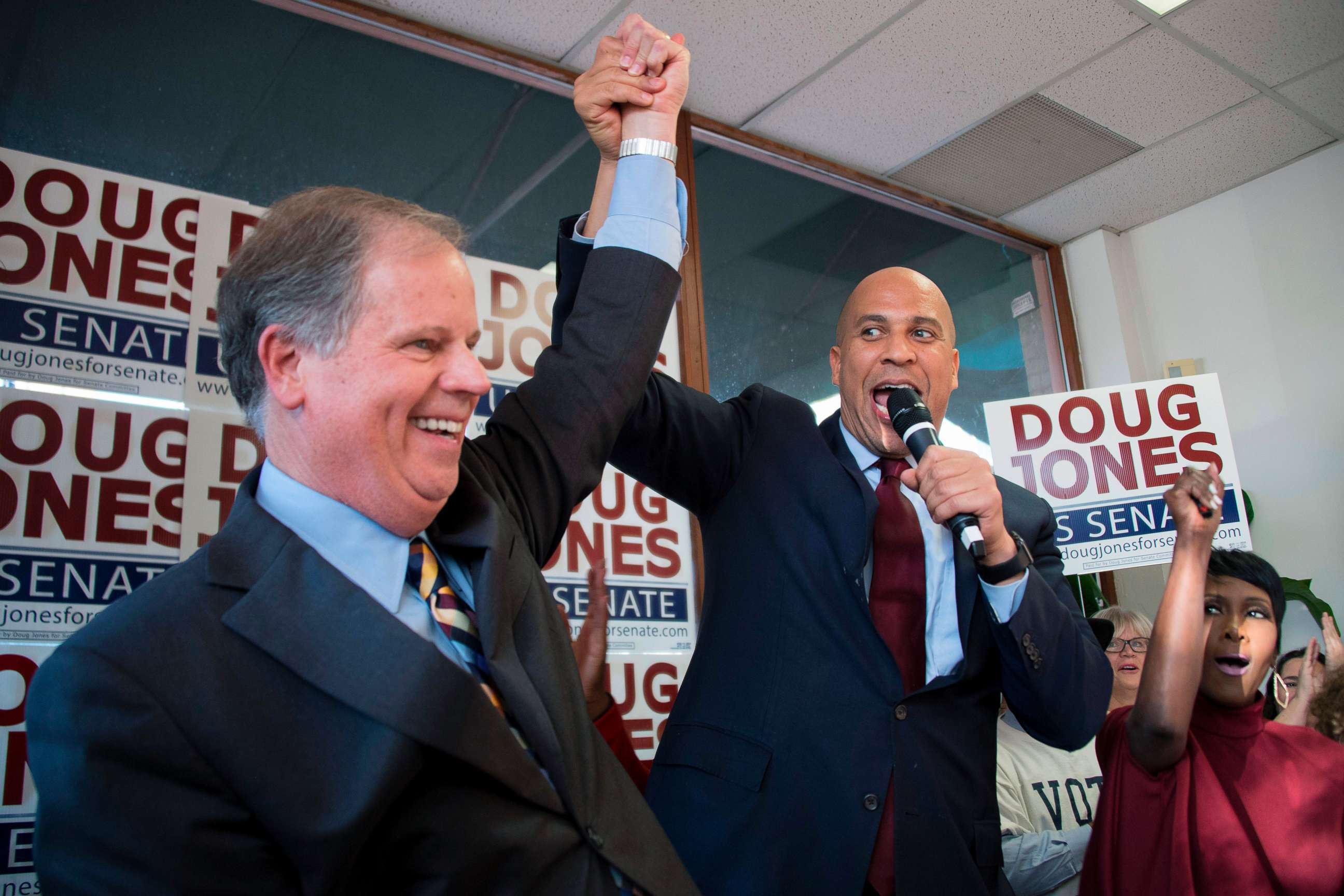 PHOTO: Senator Cory Booker raises the arm of Democratic Senatorial candidate Doug Jones while speaking at Jones' campaign headquarters in Birmingham, Alabama, Dec. 10, 2017.