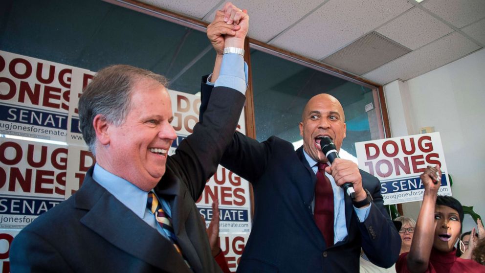 PHOTO: Senator Cory Booker raises the arm of Democratic Senatorial candidate Doug Jones while speaking at Jones' campaign headquarters in Birmingham, Alabama, Dec. 10, 2017.