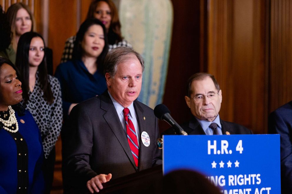 PHOTO: Sen. Doug Jones speaks during a news conference to introduce a voting rights act on Capitol Hill in Washington, Feb. 26, 2019.