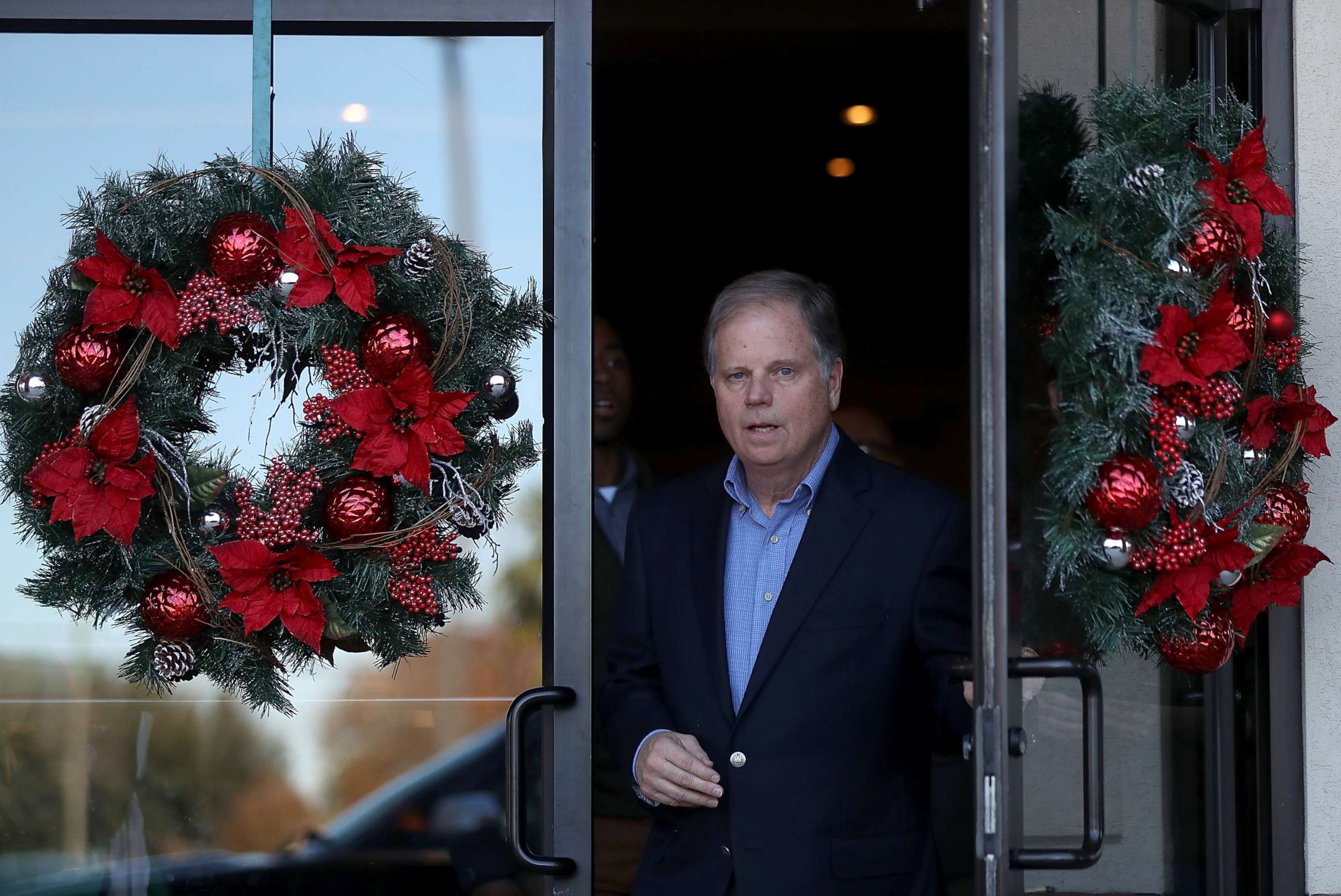 PHOTO: Democratic Senatorial candidate Doug Jones walks out of a campaign stop at Martha's Place, Dec. 11, 2017, in Montgomery, Alabama.