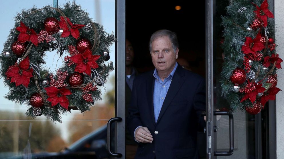 PHOTO: Democratic Senatorial candidate Doug Jones walks out of a campaign stop at Martha's Place, Dec. 11, 2017, in Montgomery, Alabama.