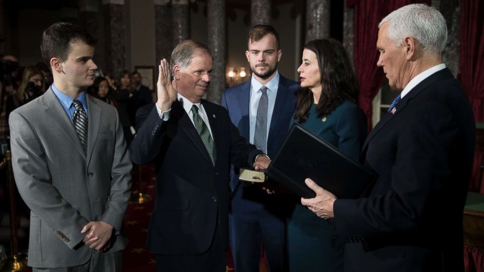 Democratic Senator Doug Jones (2-L), with his wife Louise Jones (2-R) and sons Christopher (L) and Carson Jones (C), is ceremonially sworn in by Vice President Mike Pence in the US Capitol, Jan. 3, 2018.
