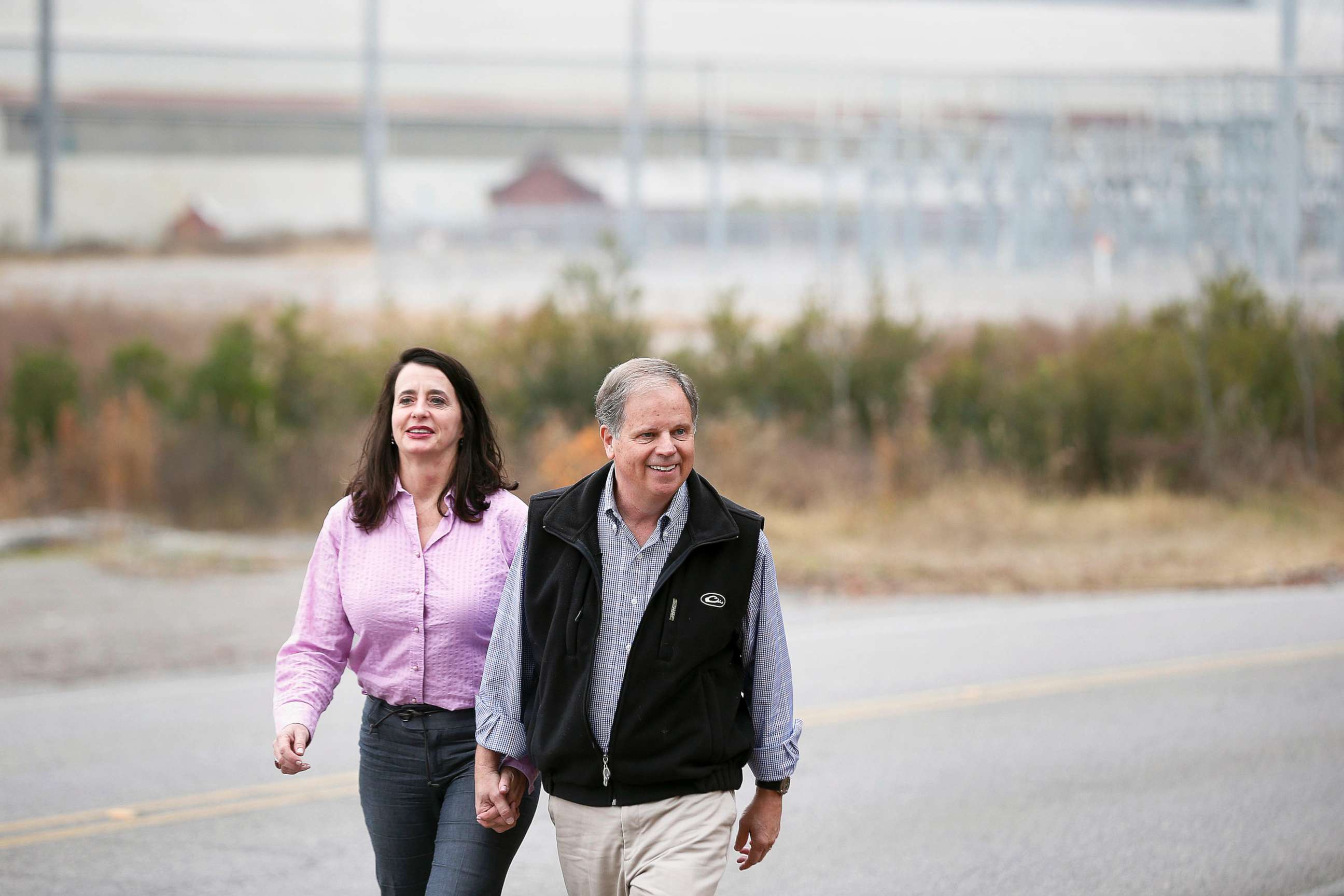 PHOTO: Democratic senatorial candidate Doug Jones, right, walks to a news conference with his wife, Louise Jones, Dec. 4, 2017, in Dolomite, Ala.