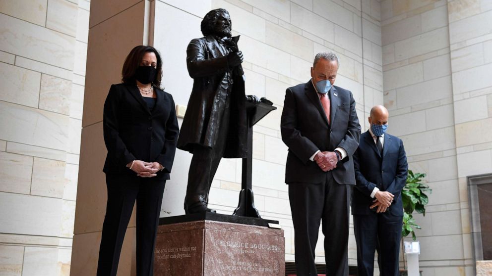 PHOTO: Standing near a statue of Frederick Douglass, Sen. Kamala Harris, D-Calif., left, Senate Minority Leader Sen. Chuck Schumer of N.Y., center, and Sen. Cory Booker, D-N.J., right, pause during a prayer on Capitol Hill in Washington, June 4, 2020.