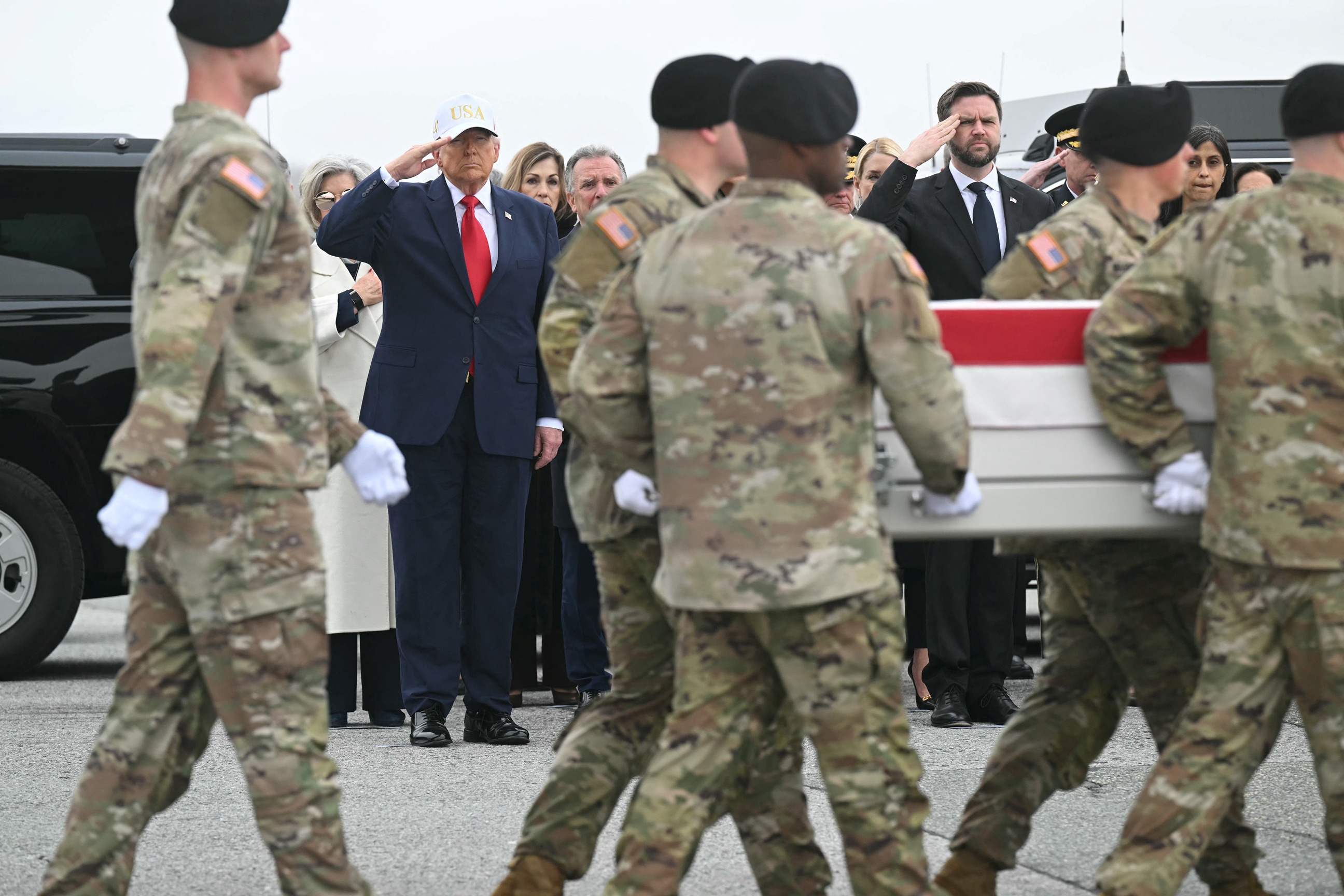 PHOTO: President Donald Trump and Vice President JD Vance salute as members of a US Army carry the flagged-drapped case containing the remains of soldier Maj. Jeffery R. O' Brien during a dignified transfer event at Dover Air Force Base on March 7, 2026. 