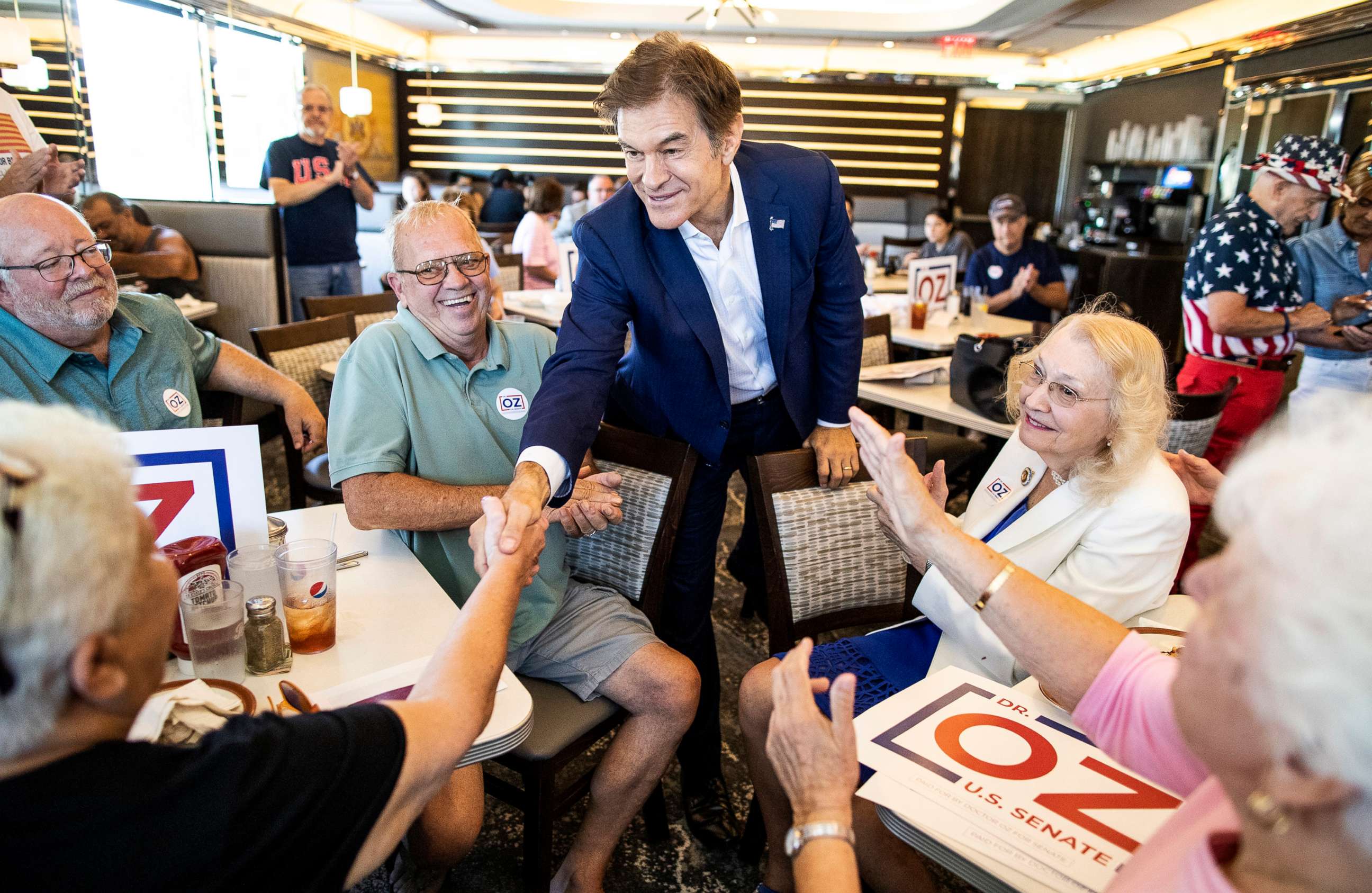 PHOTO: Republican nominee for U.S. Senate, Dr. Mehmet Oz, shakes hands with supporters at The Capitol Diner, on Aug. 12, 2022, in Swatara Township, Pa.
