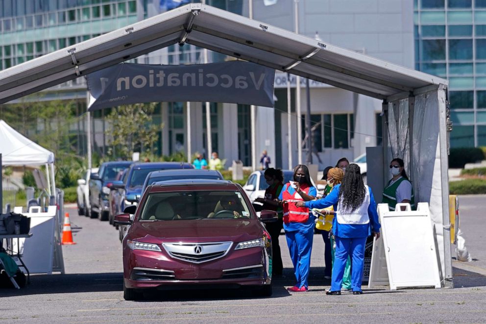 Workers administer vaccines Monday, March 29, 2021, at "Vaccine Fest," a 24-hour, drive-thru COVID-19 mass vaccination event in Metairie, Louisiana.