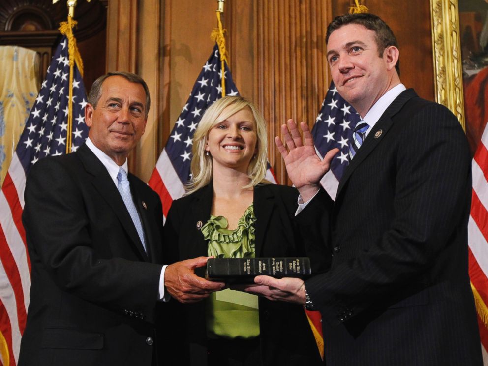 In this Jan. 5, 2011, file photo, House Speaker John Boehner of Ohio, left, administers the House oath to Rep. Duncan Hunter, R-Calif., as his wife, Margaret, looks on during a mock swearing-in ceremony on Capitol Hill in Washington.