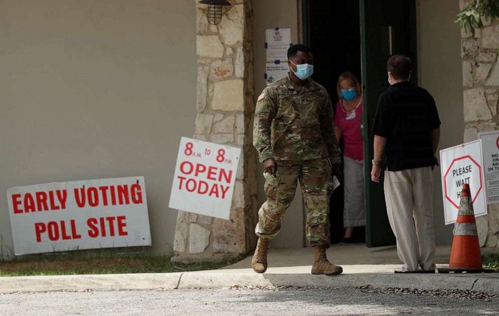 PHOTO: Ellen Ott, center, controls the flow of early voters at a polling site, Tuesday, July 7, 2020, in San Antonio.