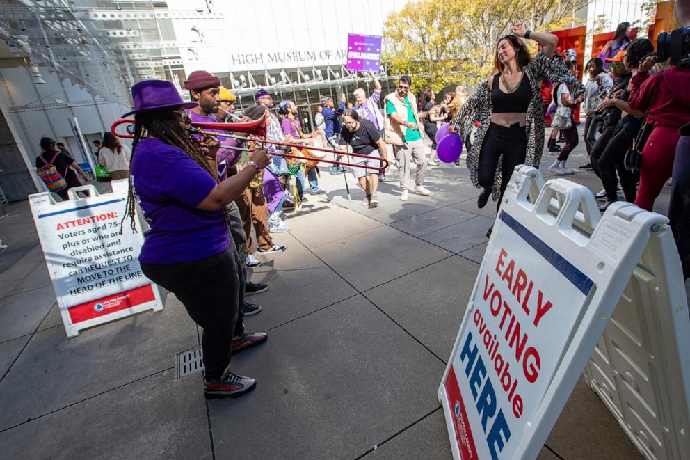 PHOTO: Party to the Polls Purple Tour performers bring joy to a polling location during the early vote period as attendees cast their ballots on Oct. 19, 2024, in Atlanta.