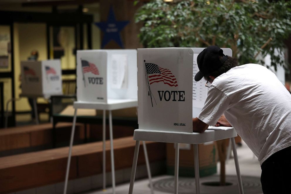 PHOTO: A voter fills out his ballot during early voting at the Santa Clara County registrar of voters office on Oct.13, 2020, in San Jose, Calif.