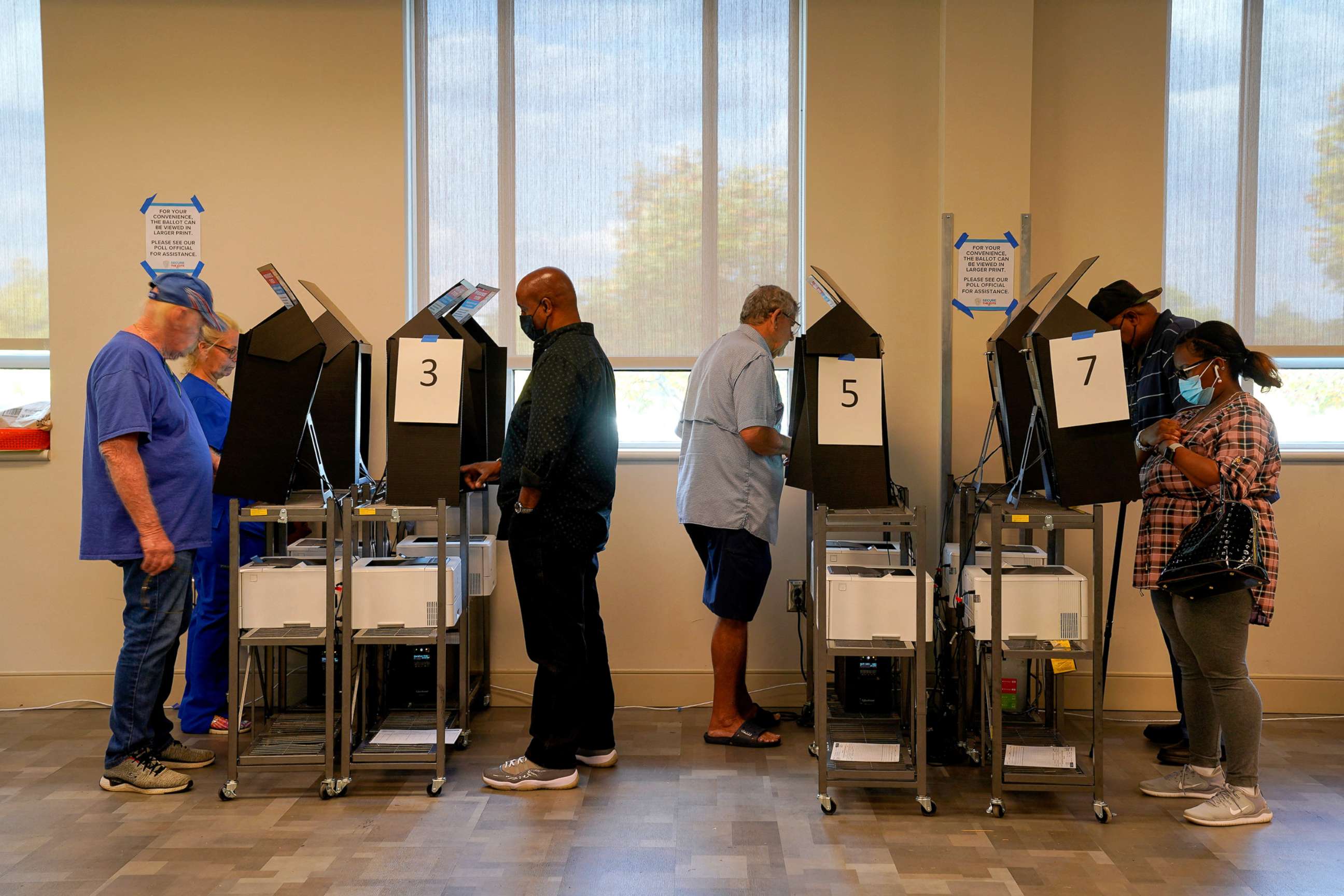 PHOTO: People use voting machines to fill out and cast their ballots as early voting begins for the midterm elections at the Citizens Service Center in Columbus, Ga., Oct. 17, 2022.