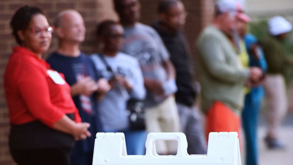 PHOTO: People wait in line to cast their ballots at the Orange County Supervisor of Elections Office on the first day of early voting for the 2022 midterm general election in Orlando, Oct. 24, 2022. 