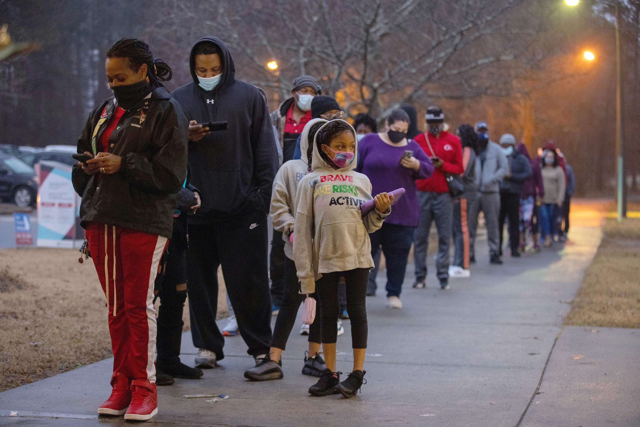 PHOTO: Voters wait in line to vote early for the Georgia senate special election at Shorty Howell Park in Duluth, Ga., Dec. 31, 2020.