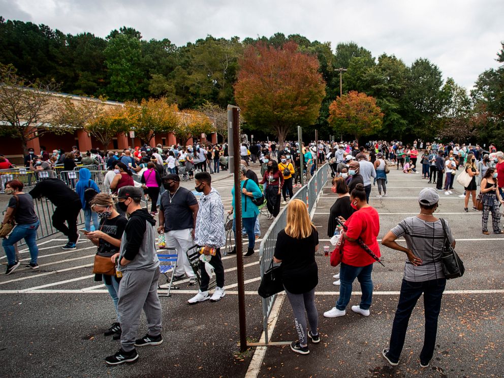 PHOTO: Hundreds of people wait in line for early voting in Marietta, Georgia, Oct. 12, 2020.