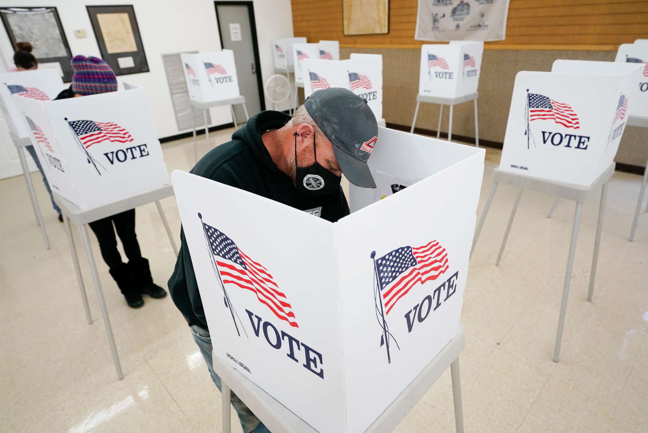 PHOTO: Chris Helps, of Earlham, Iowa, fills out his ballot during early voting, Tuesday, Oct. 20, 2020, in Adel, Iowa.