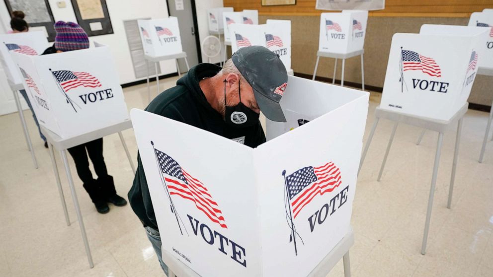PHOTO: Chris Helps, of Earlham, Iowa, fills out his ballot during early voting, Tuesday, Oct. 20, 2020, in Adel, Iowa.