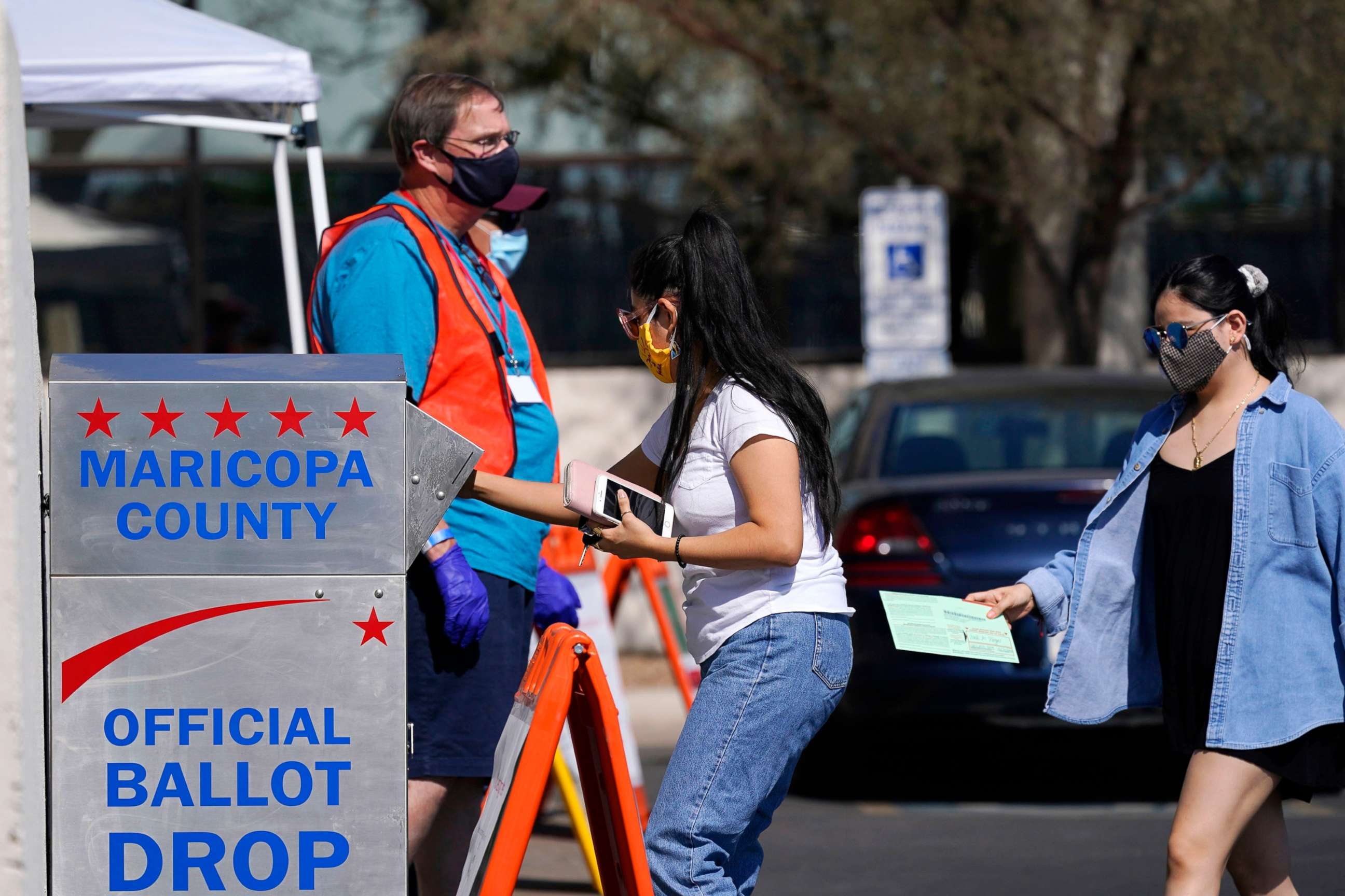 PHOTO: In this Oct. 20, 2020, file photo, voters drop off ballots as volunteers look on at the Maricopa County Recorder's Office in Phoenix.