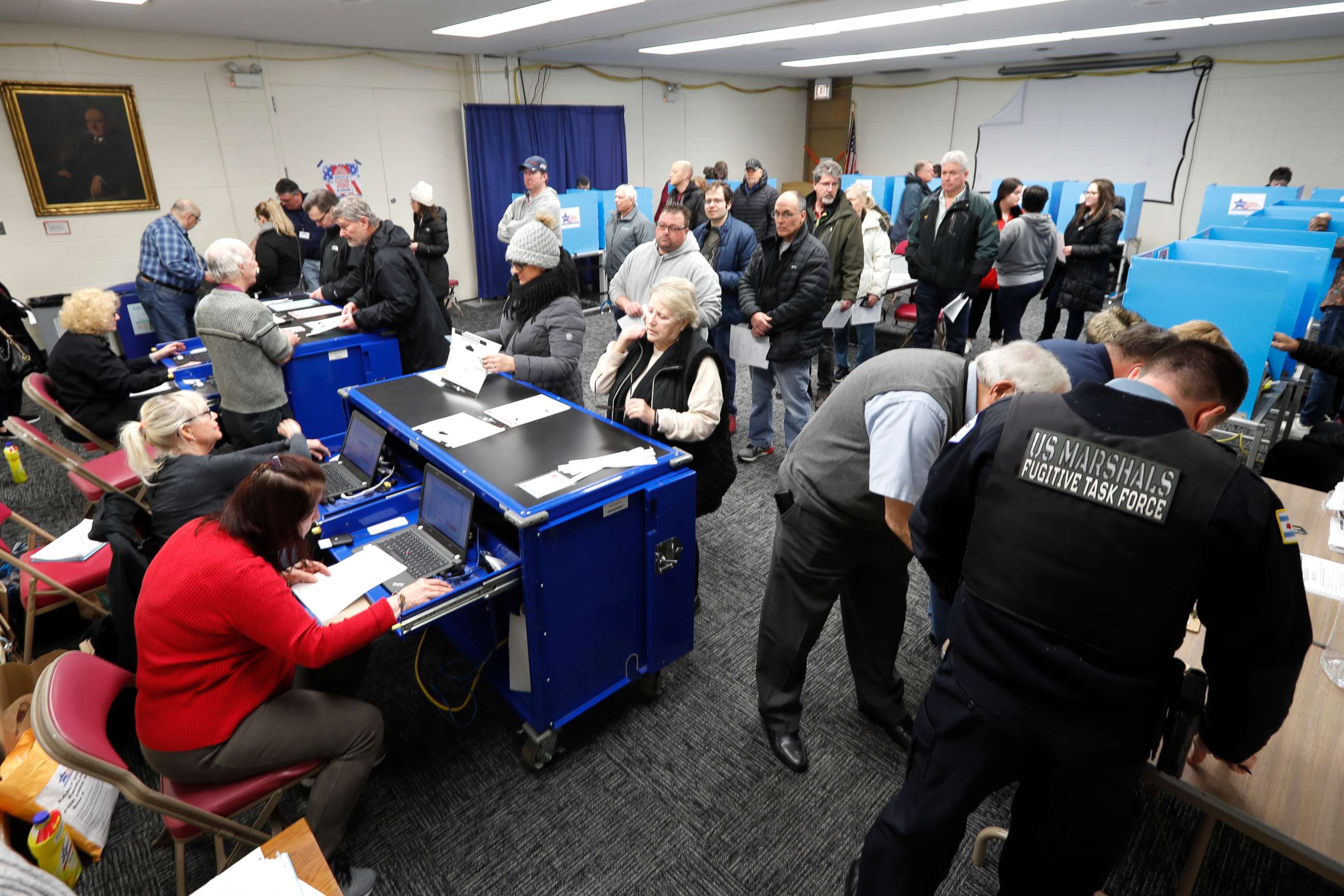 PHOTO: Chicago residents line up for early voting at the Roden Library Monday, March 16, 2020, in Chicago. 