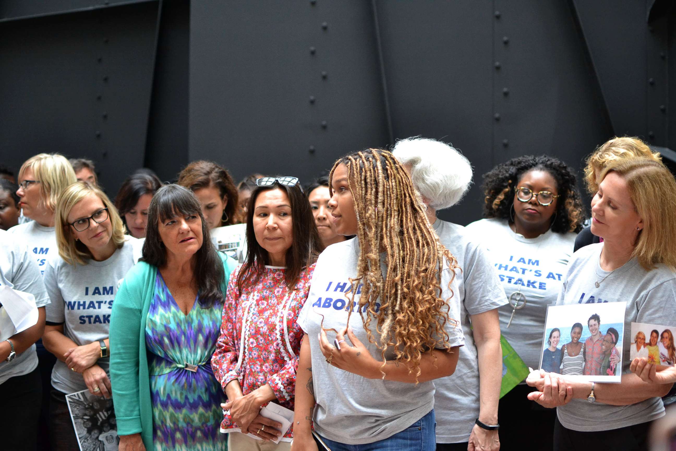 PHOTO: Ebony Wiggins, women's health activist and volunteer, talks to other protesters in the Hart Senate office building.