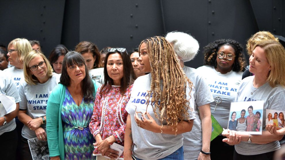 PHOTO: Ebony Wiggins, women's health activist and volunteer, talks to other protesters in the Hart Senate office building.