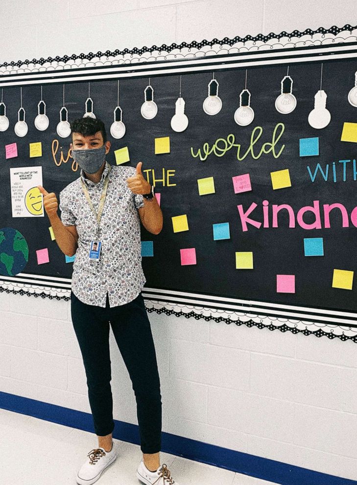 PHOTO: Jonathan Kryk stands in front of a kindness board on the first day of school last year in which students leave notes of love and appreciation for others, Sept. 2021.