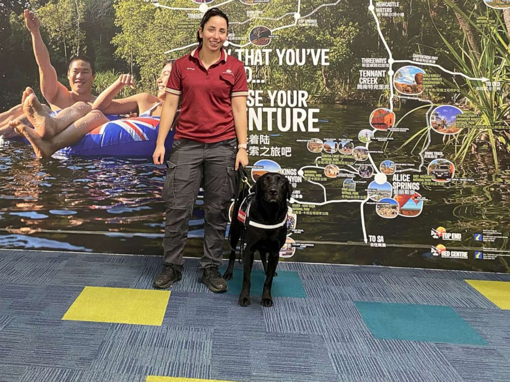 PHOTO: Detector dog Zinta is shown with her handler at Darwin airport in Darwin, Australia.