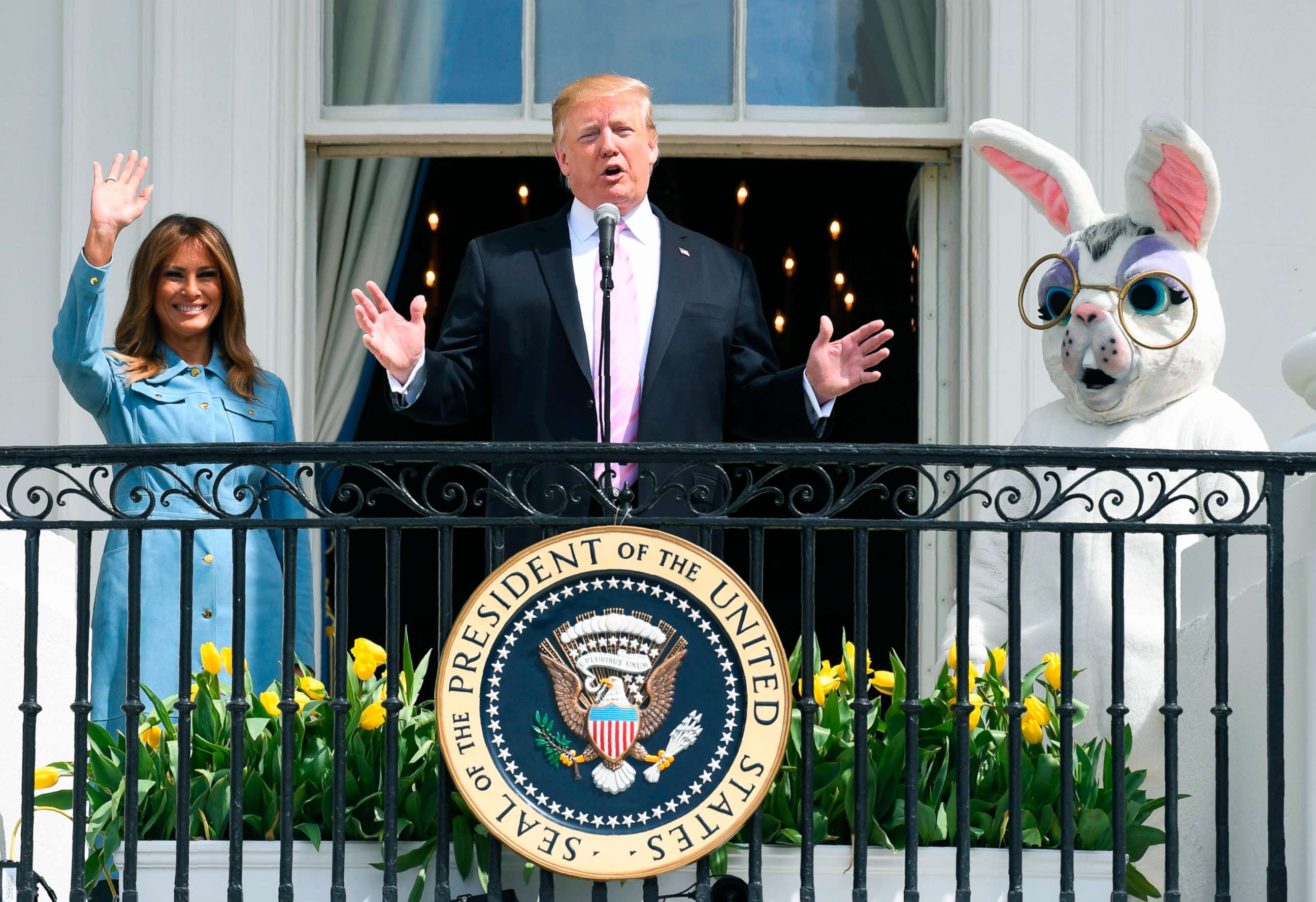 PHOTO: President Donald Trump speaks as First Lady Melania Trump waves during the annual White House Easter Egg Roll on the South Lawn of the White House, April 22, 2019.