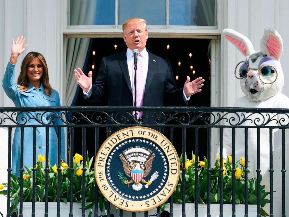 PHOTO: President Donald Trump speaks as First Lady Melania Trump waves during the annual White House Easter Egg Roll on the South Lawn of the White House, April 22, 2019.
