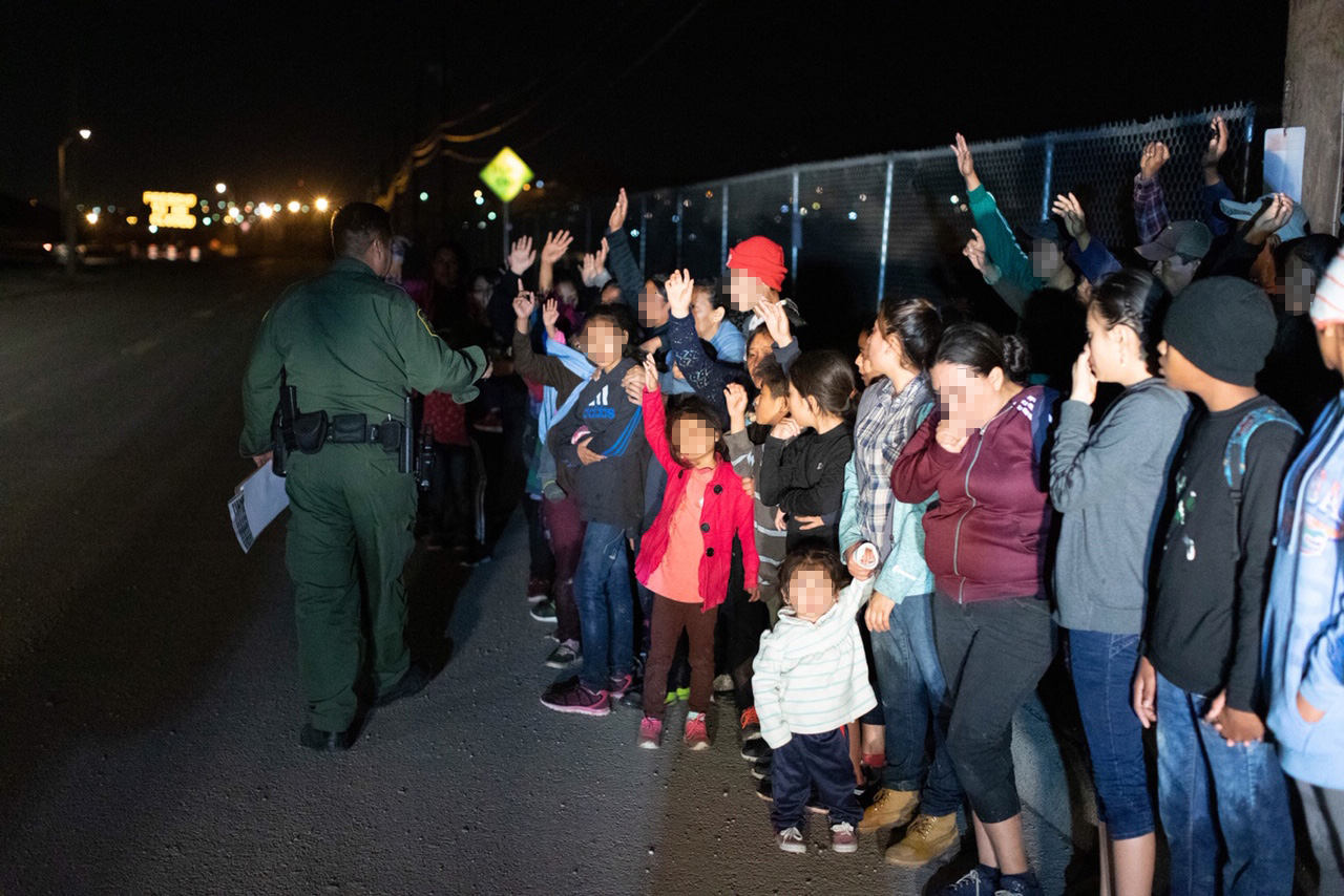 PHOTO: Migrants are seen lined up in El Paso, Texas, on March 23, 2019, after crossing the international border between the United States and Mexico and surrendering to a border patrol agent.