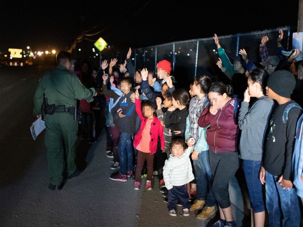 PHOTO: Migrants are seen lined up in El Paso, Texas, on March 23, 2019, after crossing the international border between the United States and Mexico and surrendering to a border patrol agent.